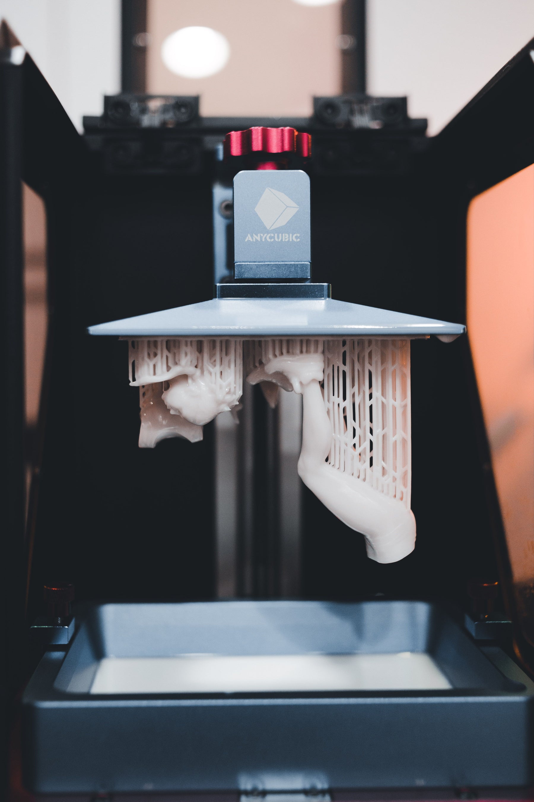 Close-up of a resin 3D printer in operation, used to print conversion bits for wargaming miniatures