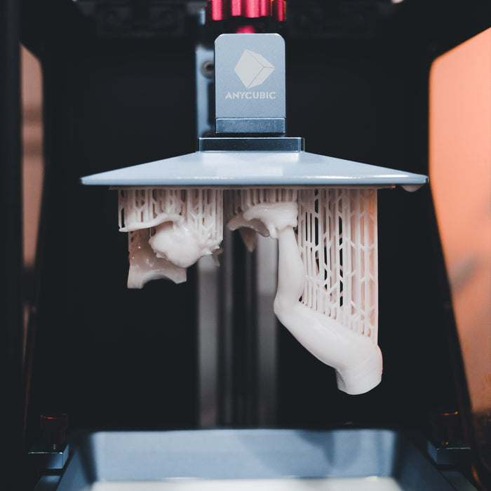 Close-up of a resin 3D printer in operation, used to print conversion bits for wargaming miniatures