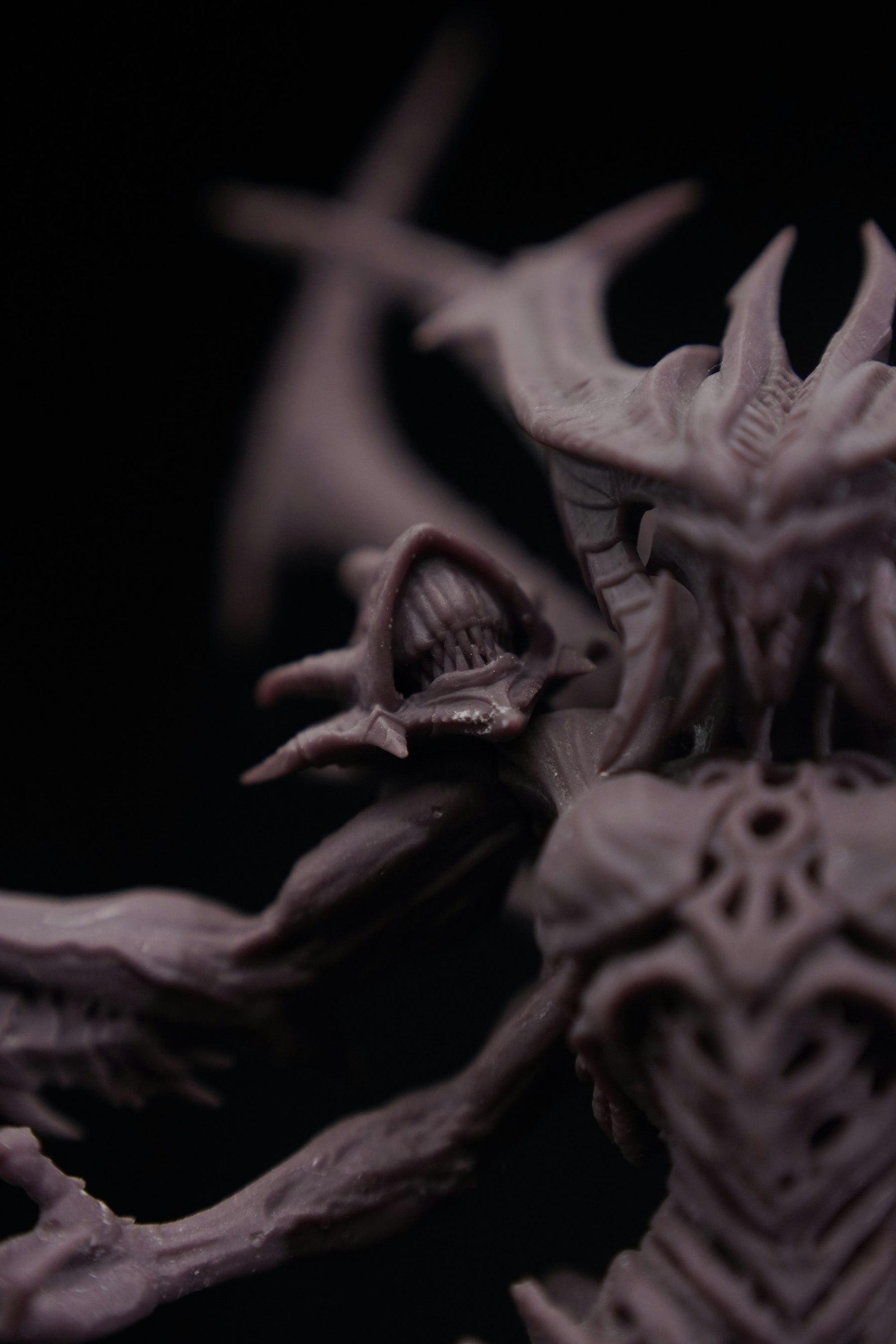 Close-up of a highly detailed 3D-printed resin fantasy miniature showing fine heroic-scale surface detail