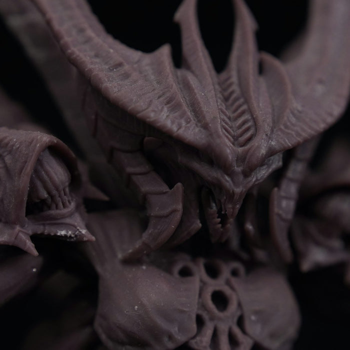 A bare grey resin 3D-printed fantasy demon miniature, unpainted and ready for cleaning and priming
